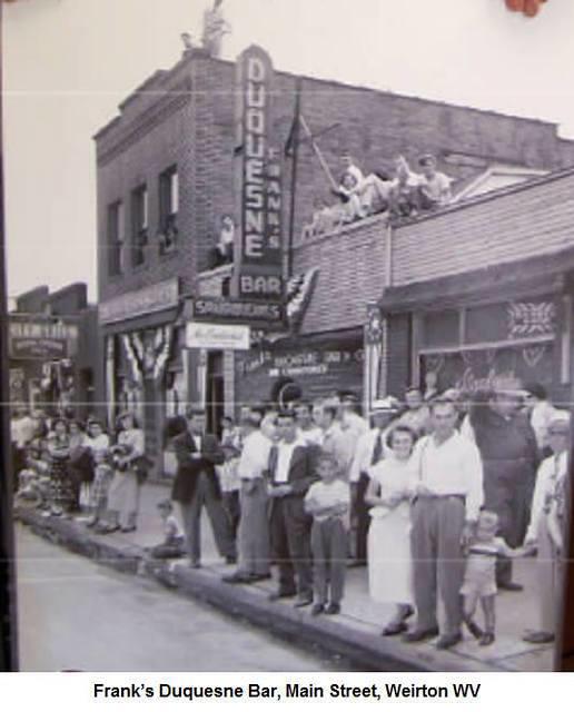 Frank’sDuquesneBar_ManStreetWeirton_OwnerFrankCrisciKneelingOnRoofLeftOfSign.jpg