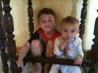 The Little Guy and Mini-mini me playing under the hall table.