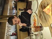 Luciano's First Bit of Pizza