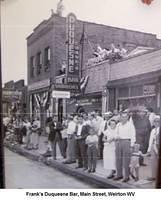 Frank’sDuquesneBar_ManStreetWeirton_OwnerFrankCrisciKneelingOnRoofLeftOfSign.jpg